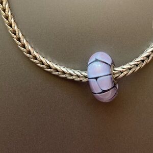 Trollbead dark and light purple glass bead